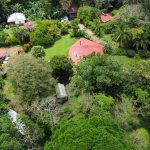 aerial photo of arenal lake property with home and cabins.